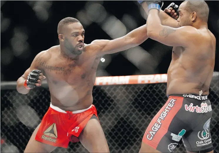  ?? — GETTY IMAGES FILES ?? Light-heavyweigh­t Jon Jones, left, jabs at Daniel Cormier at UFC 182 in January 2015 in Las Vegas. Jones and Cormier will battle again next month.