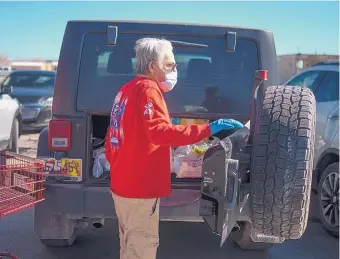  ?? ROBERTO E. ROSALES/JOURNAL ?? Gallup resident Phillip Silva on Friday bought essentials for the weekend as a lockdown was ordered for the city.