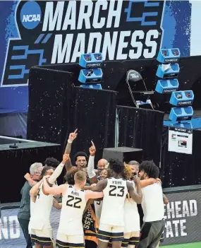  ?? MARK HUMPHREY/AP ?? West Virginia players and coaches celebrate after beating Morehead State in a first-round NCAA Tournament game Saturday in Indianapol­is.