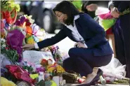  ?? ANDREW HARNIK - THE ASSOCIATED PRESS ?? New York Gov. Kathy Hochul looks at a memorial at the scene of a shooting at a supermarke­t as she pays respects to the victims of Saturday’s shooting in Buffalo, N.Y., Tuesday.