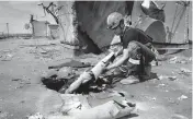  ?? SOFIIA BOBOK AP ?? Ukrainian rescuers search for and retrieve the remains of Russian shells on the roof of a high-rise building damaged by Russian shelling Thursday in a residentia­l area of Kharkiv.