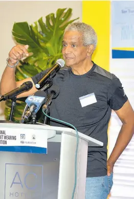  ?? PHOTO BY ANTOINE LODGE ?? Crash survivor John McFarlane sharing his 1970’s crash experience with the audience at the launch of the National Helmet Wearing Collation held yesterday at the AC Marriot Hotel.