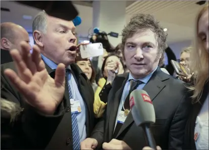  ?? MARKUS SCHREIBER — THE ASSOCIATED PRESS ?? Argentina President Javier Milei makes his way through the crowd of reporters and supporters after delivering his speech at the Annual Meeting of World Economic Forum in Davos, Switzerlan­d, on Wednesday.