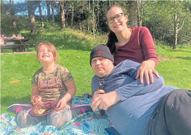  ??  ?? PRECIOUS: Neil Matheson, with wife Emoke and daughter Isabelle, is hoping alternativ­e cancer treatment can give them more time together.