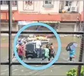  ??  ?? A picture has gone viral in social media, which shows the body of a woman being ferried on the roof of an auto rickshaw through a waterlogge­d street in Nalasopara.