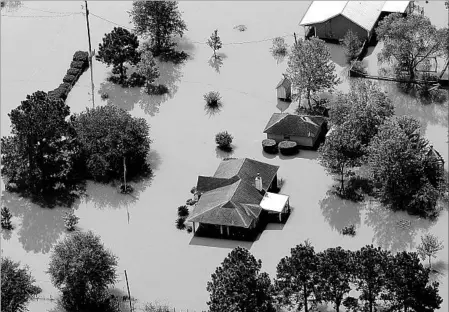  ?? DAVID J. PHILLIP/ASSOCIATED PRESS ?? The swollen Neches River has overwhelme­d a water pumping station in Beaumont, Texas, and left the city of nearly 120,000 without drinking water.