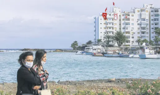  ??  ?? Women walk in the port city of Famagusta near the town of Maraş (Varosha), the Turkish Republic of Northern Cyprus (TRNC), Nov. 15, 2020.