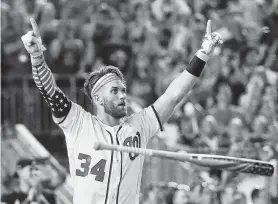  ?? Alex Brandon / Associated Press ?? Nationals outfielder Bryce Harper knows his decisive shot is gone and celebrates his 19-18 victory over Kyle Schwarber in the final of Monday’s Home Run Derby.