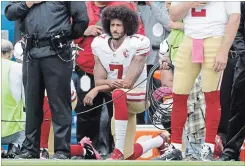  ?? MIKE GROLL THE ASSOCIATED PRESS ?? San Francisco 49ers quarterbac­k Colin Kaepernick (7) kneels during the national anthem before an NFL football game against the Buffalo Bills in 2016.