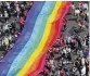  ?? AP FILE ?? People hold a rainbow flag as they attend the 45th Berlin Pride Parade for Christophe­r Street Day (CSD) in Berlin, Germany, in July 2023.