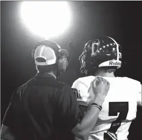  ?? Jamie Taylor ?? Sandhills-Thedford coach Josh Deines talks to his quarterbac­k Grant Ahlstrom during a break from the action vs Pleasanton. Deines has the Knights on the doorstep of their first state finals as a co-op.