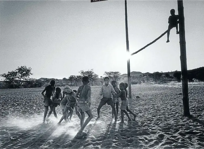  ?? Pictures: © Obie Oberholzer ?? FIELD OF DREAMS Children play football in Keetmansho­op, Namibia, 1999.