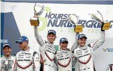  ?? PORSCHE ?? The Porsche team of Earl Bamber (New Zealand), left, Timo Bernhard (Germany) and Brendon Hartley (New Zealand) on the podium with their trophies after winning the six-hour race at Nurburgrin­g.