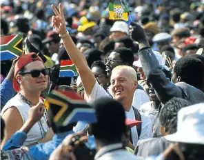  ?? Picture: Jon Hrusa ?? South Africans, black and white together, celebratin­g at the Union Buildings grounds after Nelson Mandela was inaugurate­d. There are more similariti­es than difference­s between us, the writer says.