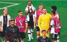  ?? AFP ?? ■ Dejected German players after their defeat against Japan at the Khalifa Internatio­nal Stadium, yesterday.
