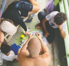  ??  ?? Passengers aboard the Kiara I — some locals, some travellers — play cards to pass the time during their three-day journey from Yurimaguas to Iquitos.