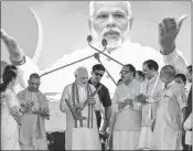  ??  ?? PM Modi and Uttar Pradesh Chief Minister Yogi Adityanath with Party leaders during the 'Kisan Kalyan' rally at Shahjahanp­ur on Saturday