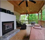  ??  ?? Left: The tiled master bath offers a jetted tub, a separate shower, a double vanity, a dressing table and more. Right: An outdoor   replace warms the covered deck, which overlooks the golf course.