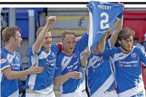  ??  ?? Tribute: Saints players hold up Mackay’s shirt to celebrate after scoring