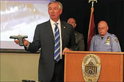  ?? CARL HESSLER JR. — DIGITAL FIRST MEDIA ?? Montgomery County District Attorney Kevin R. Steele displays the guns that authoritie­s seized during “Operation Poison Control,” the investigat­ion that dismantled a drug traffickin­g network distributi­ng fentanyl and cocaine.