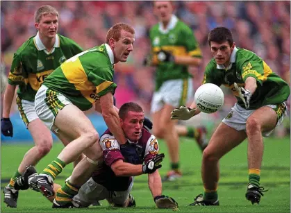  ??  ?? PRESURE: Sean de Paor of Galway is tackled by Kerry’s Liam Hassett and Aodán MacGearail­t in the 2000 final replay