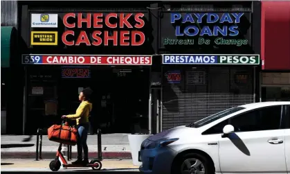  ?? ?? A check-cashing and payday loans store in downtown Los Angeles, California, on 11 March 2022. Photograph: Patrick T Fallon/AFP/Getty Images