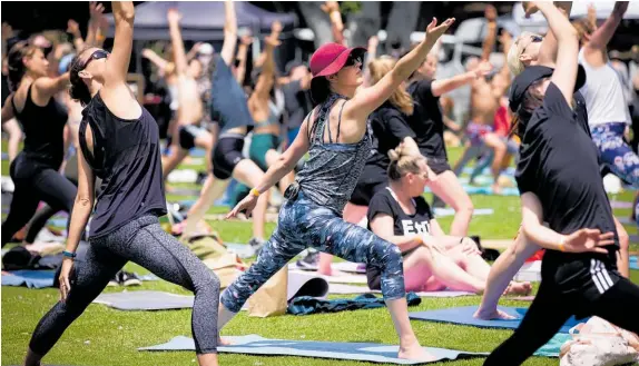  ?? Photo / Dean Purcell ?? Sunglasses, SPF and hats got a good workout at NZ Yoga Day at Western Springs yesterday — but won’t be needed later this week.