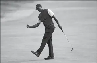  ?? PETER MORRISON/AP PHOTO ?? Tiger Woods celebrates a birdie on the ninth hole during the third round of the British Open on Saturday in Carnoustie, Scotland. Woods shot a 5-under-par 66 and is only four strokes back heading into today’s final round.