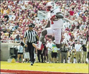  ?? Mark Wallheiser The Associated Press ?? North Carolina State tight end Jaylen Samuels bounds into the end zone on a 14-yard touchdown catch in the fourth quarter of the Wolfpack’s 2721 win over No. 12 Florida State on Saturday.