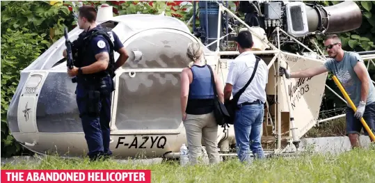  ??  ?? Spirited away: The helicopter used by the gang after being dumped near Charles de Gaulle airport in Paris yesterday THE ABANDONED HELICOPTER