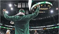  ?? CHARLES KRUPA THE ASSOCIATED PRESS ?? Boston Celtics guard Isaiah Thomas celebrates from the bench late in the fourth quarter during Wednesday’s game against the Milwaukee Bucks in Boston. With the Celtics’ regular-season finale 112-94 win, they claim the No. 1 seed in the Eastern...