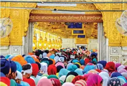  ?? — PTI ?? Devotees pay obeisance at the sanctum of the Golden Temple on the occasion of Baisakhi festival in Amritsar on Tuesday.