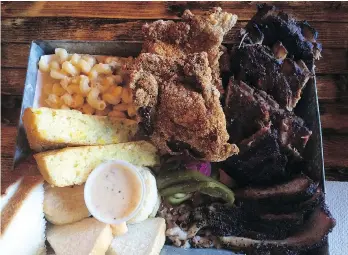  ?? MIA STAINSBY ?? A platter of ribs, chicken, brisket and fixings at Dixie’s BBQ, a Central Texas-style BBQ joint on East Hastings. The briskets sit in a smoker for eight hours and the ribs for three hours.