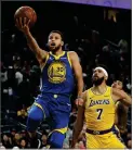  ?? AP FILE PHOTO BY JOHN LOCHER ?? In this Oct. 10, photo, Golden State Warriors guard Stephen Curry shoots next to Los Angeles Lakers center Javale Mcgee during the second half of an NBA preseason basketball game, in Las Vegas.