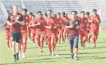  ??  ?? Sarawak players warm up during training yesterday.