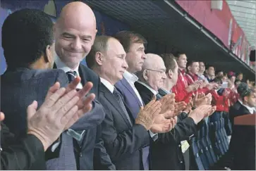  ?? Alexei Druzhinin European Pressphoto Agency ?? RUSSIAN PRESIDENT Vladimir Putin, third from left, FIFA President Gianni Infantino, second from left, and soccer great Pele, left, applaud before the Confederat­ions Cup opener in St. Petersburg, Russia.