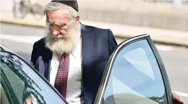  ??  ?? Rabbi Daniel Greer, 77, of New Haven, leaves New Haven Superior Court on Elm Street in New Haven yesterday morning after he was arraigned on a criminal charge of second-degree sexual assault and risk of injury to a minor.