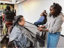  ?? ?? Charndry Lee works on Joyce Iulio-Sua’s braid at a free hair clinic on Saturday at D.R.I.P. Fest. “I love the atmosphere and knowing I’m doing something good for the community,” Lee said.