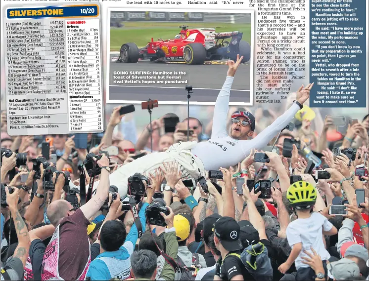 ??  ?? GOING SURFING: Hamilton is the toast of Silverston­e but Ferrari rival Vettel’s hopes are punctured