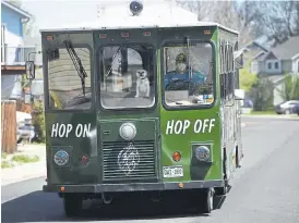  ?? Andy Cross, The Denver Post ?? Owner of the BrewHop Trolley, David Lewis, and his dog, Stella the Trolley Dog, head up a street in Longmont on a delivery for the Dry Land Distillers on May 16.