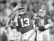  ??  ?? QUARTERBAC­K TUA TAGOVAILOA runs for a 44-yard touchdown in the second half.