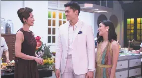  ?? Sanja Bucko / Associated Press ?? From left, Michelle Yeoh, Henry Golding and Constance Wu in a scene from the film ‘Crazy Rich Asians’.