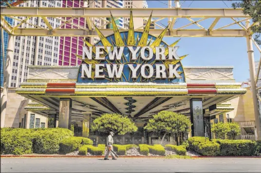  ?? L.E. Baskow Las Vegas Review-Journal @Left_Eye_Images ?? A landscaper blows clippings after trimming the bushes Friday in front of the New York-New York, which reopens Thursday.