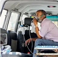  ?? DEEPAK DESHPANDE ?? A man with oxygen support wait in an ambulance for a bed to get admitted at King Koti hospital on Wesnesday.
—