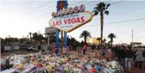  ?? - Reuters file ?? FIRST ANNIVERSAR­Y: The ‘Welcome to Las Vegas’ sign is surrounded by flowers and items, left after the October 1 mass shooting, in Las Vegas, Nevada, US.