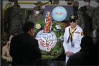  ?? (AP/The Union/Elias Funez) ?? World War II veterans pose in front of a wreath commemorat­ing the 80th anniversar­y of the attack on Pearl Harbor.