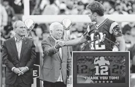  ?? ERIC CANHA USA TODAY NETWORK ?? Tom Brady shakes hands with New England Patriots owner Robert Kraft during a halftime ceremony in his honor during the game between the Philadelph­ia Eagles and New England Patriots at Gillette Stadium in Foxborough, Mass., on Sept. 10, 2023.