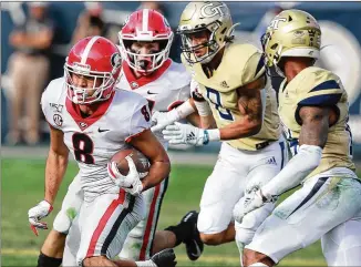  ?? CURTIS COMPTON / CCOMPTON@AJC.COM ?? UGA’s Dominick Blaylock makes a reception against Tech last season. Tech and UGA have played 114 times, including every year since 1925. This year’s game is Nov. 28 in Athens.
