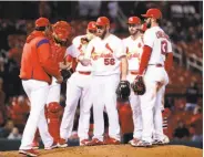  ?? Jeff Roberson / Associated Press ?? St. Louis relief pitcher Greg Holland (56) is pulled by manager Mike Matheny after walking four.