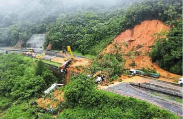  ?? ?? Massive damage: The landslide struck after heavy rains in Parana state, sweeping away everything in its path, including a chunk of the highway and the vehicles on it. — reuters